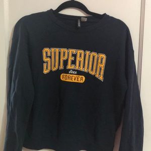 A navy blue sweatshirt with yellow lettering